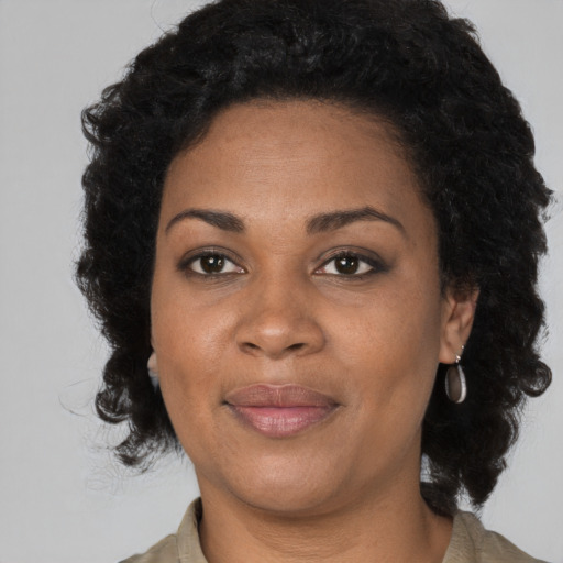 Joyful black adult female with medium  black hair and brown eyes