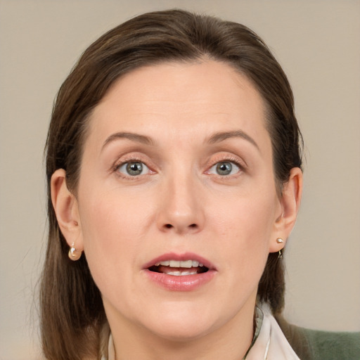 Joyful white adult female with medium  brown hair and grey eyes