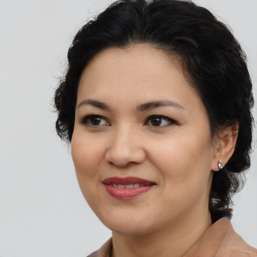 Joyful asian adult female with medium  brown hair and brown eyes