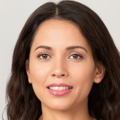 Joyful white young-adult female with long  brown hair and brown eyes