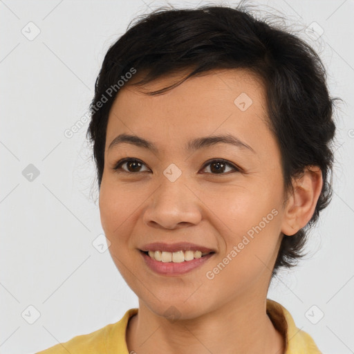 Joyful latino young-adult female with medium  brown hair and brown eyes