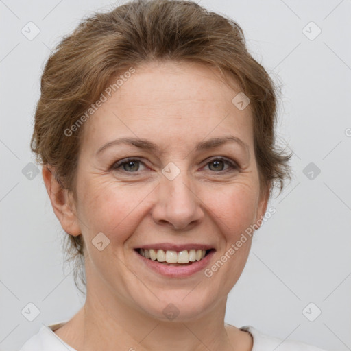 Joyful white adult female with short  brown hair and grey eyes