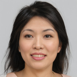 Joyful asian young-adult female with medium  brown hair and brown eyes