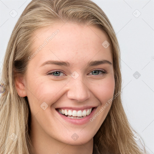 Joyful white young-adult female with long  brown hair and blue eyes