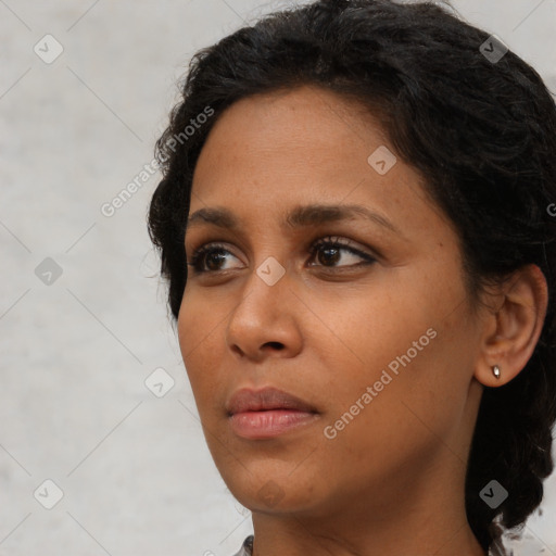 Neutral black young-adult female with medium  brown hair and brown eyes