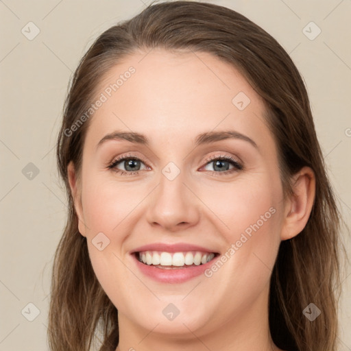 Joyful white young-adult female with long  brown hair and green eyes