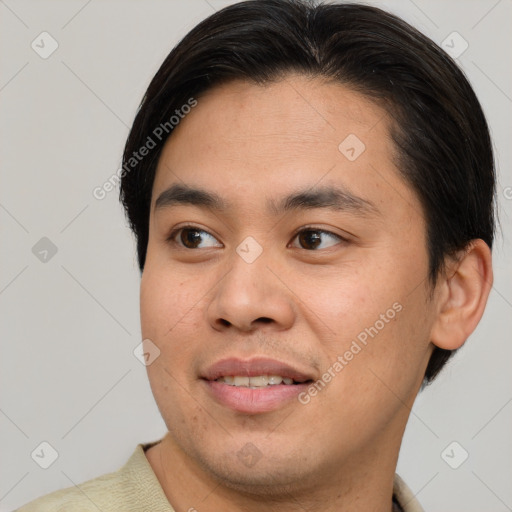 Joyful asian young-adult male with short  brown hair and brown eyes