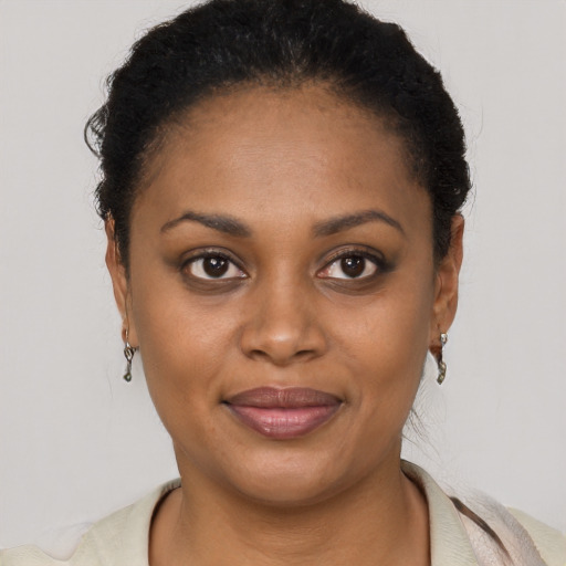 Joyful black young-adult female with short  brown hair and brown eyes