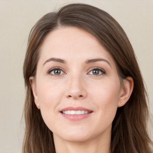 Joyful white young-adult female with long  brown hair and grey eyes