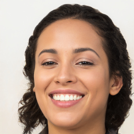 Joyful latino young-adult female with long  brown hair and brown eyes