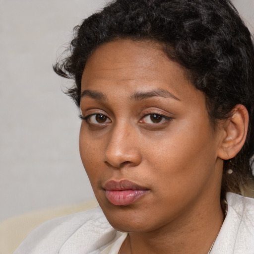 Neutral black young-adult female with short  black hair and brown eyes