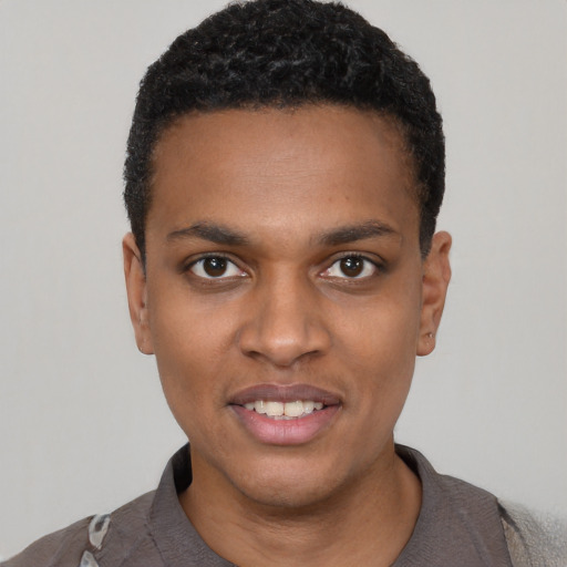 Joyful black young-adult male with short  black hair and brown eyes