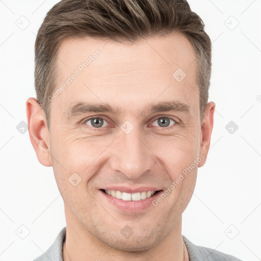 Joyful white young-adult male with short  brown hair and grey eyes