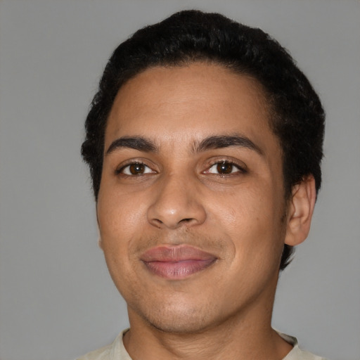 Joyful latino young-adult male with short  black hair and brown eyes