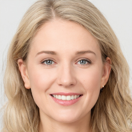 Joyful white young-adult female with long  brown hair and blue eyes