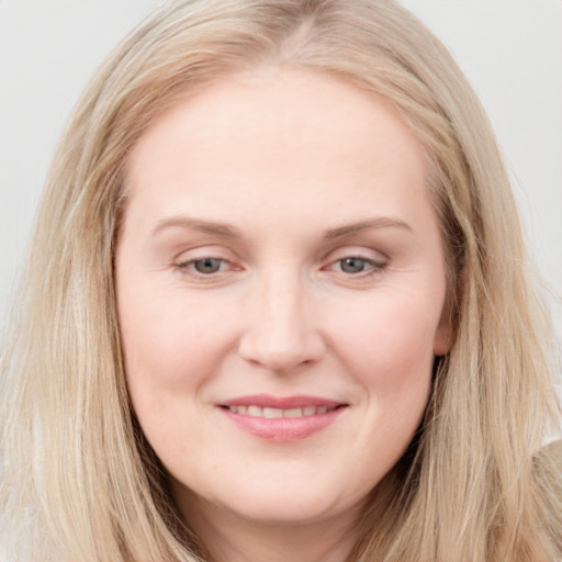 Joyful white young-adult female with long  brown hair and blue eyes