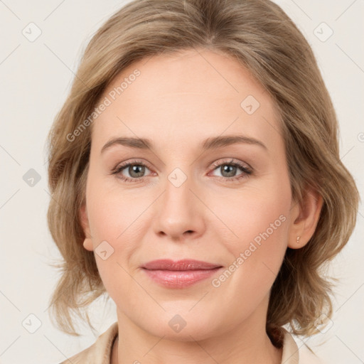 Joyful white young-adult female with medium  brown hair and green eyes