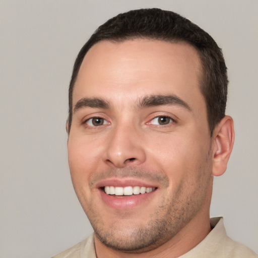 Joyful white young-adult male with short  brown hair and brown eyes