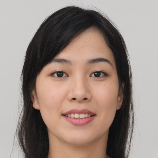 Joyful asian young-adult female with long  brown hair and brown eyes