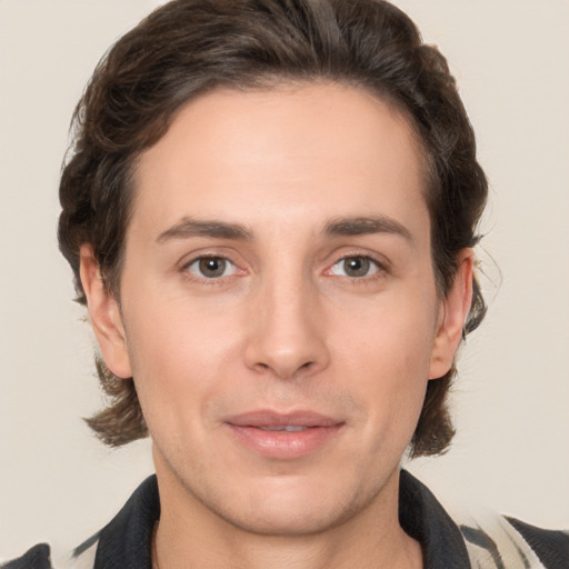 Joyful white young-adult male with medium  brown hair and brown eyes