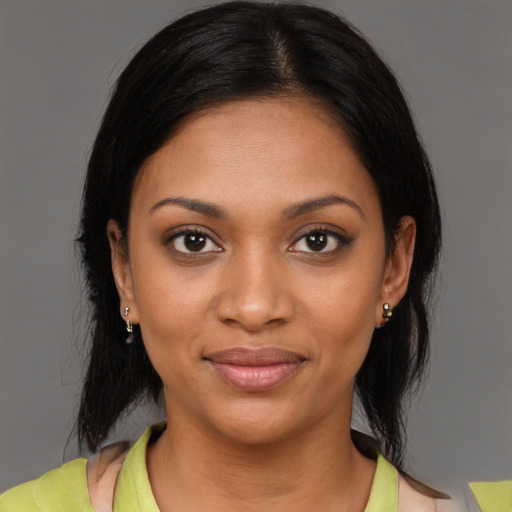 Joyful black young-adult female with medium  black hair and brown eyes