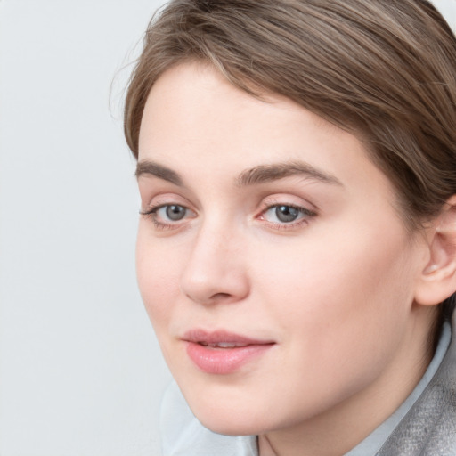 Joyful white young-adult female with medium  brown hair and blue eyes