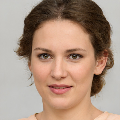 Joyful white young-adult female with medium  brown hair and green eyes