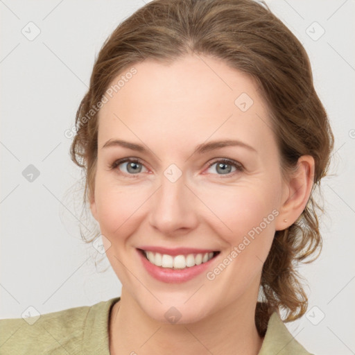 Joyful white young-adult female with medium  brown hair and green eyes