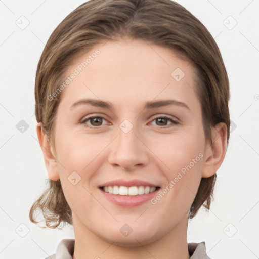 Joyful white young-adult female with medium  brown hair and grey eyes