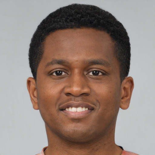 Joyful latino young-adult male with short  brown hair and brown eyes