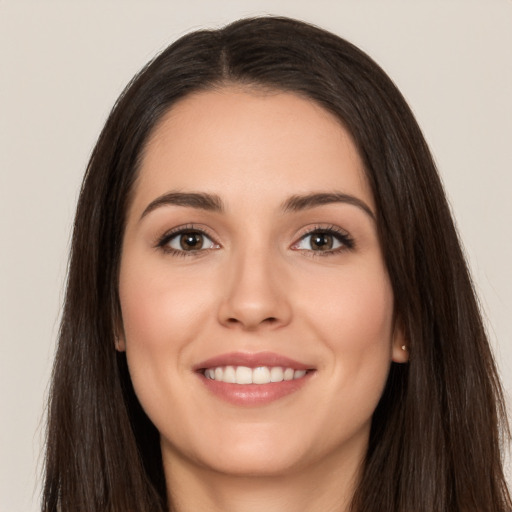 Joyful white young-adult female with long  brown hair and brown eyes