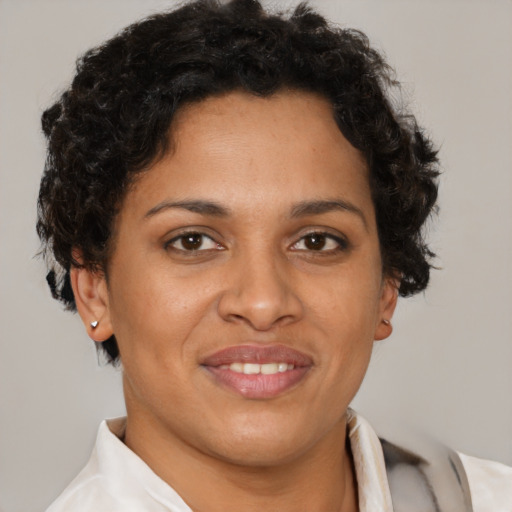 Joyful latino young-adult female with short  brown hair and brown eyes