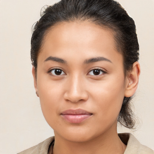 Joyful latino young-adult female with medium  brown hair and brown eyes