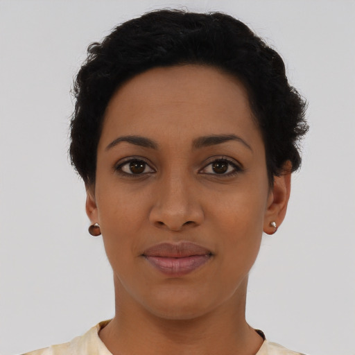Joyful latino young-adult female with short  black hair and brown eyes
