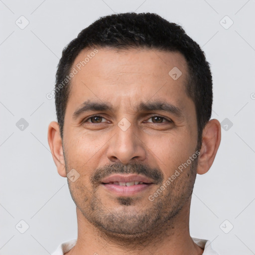 Joyful white young-adult male with short  black hair and brown eyes