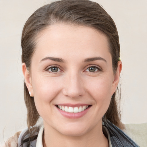 Joyful white young-adult female with medium  brown hair and grey eyes