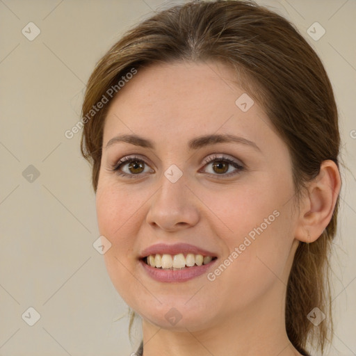 Joyful white young-adult female with long  brown hair and brown eyes