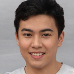 Joyful asian young-adult male with short  black hair and brown eyes