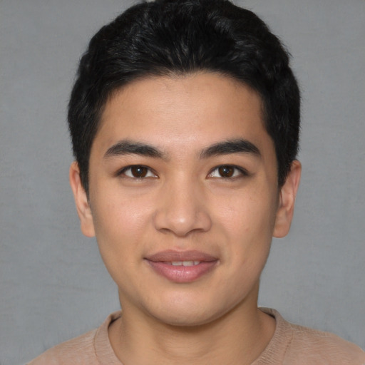Joyful asian young-adult male with short  black hair and brown eyes