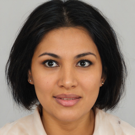 Joyful latino young-adult female with medium  brown hair and brown eyes