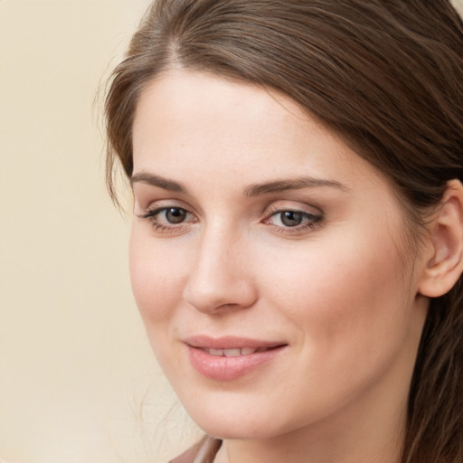 Joyful white young-adult female with medium  brown hair and brown eyes