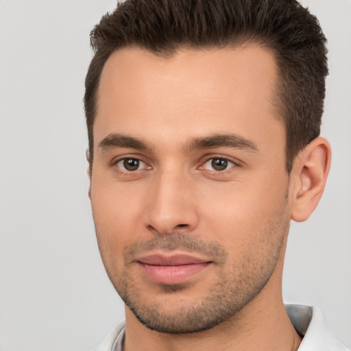 Joyful white young-adult male with short  brown hair and brown eyes