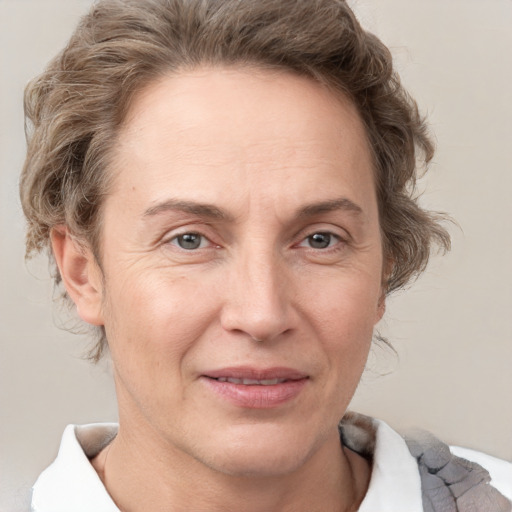 Joyful white adult female with short  brown hair and grey eyes