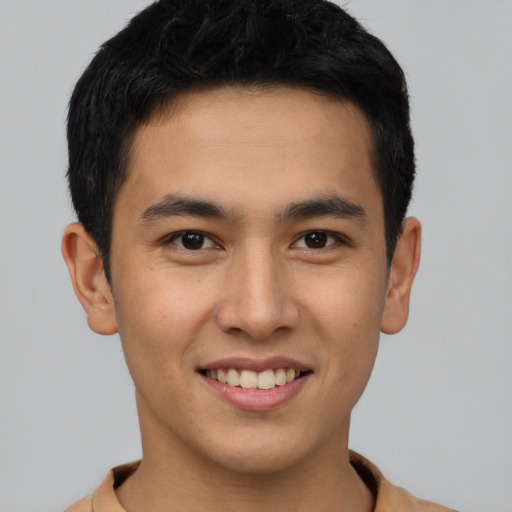 Joyful latino young-adult male with short  black hair and brown eyes