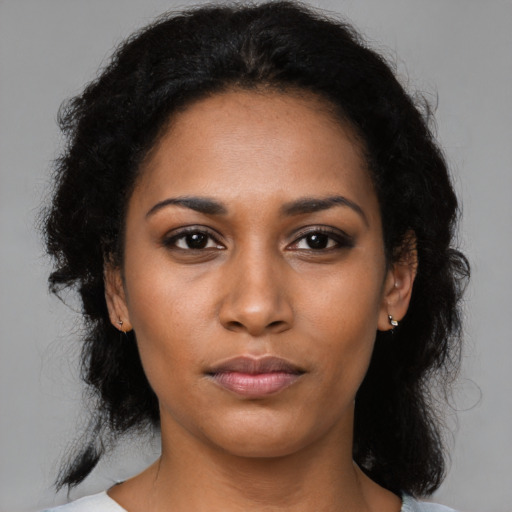 Neutral black young-adult female with medium  brown hair and brown eyes