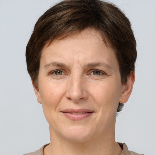 Joyful white adult female with short  brown hair and grey eyes