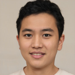 Joyful asian young-adult male with short  brown hair and brown eyes