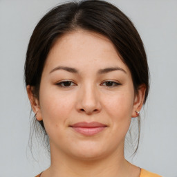 Joyful asian young-adult female with medium  brown hair and brown eyes