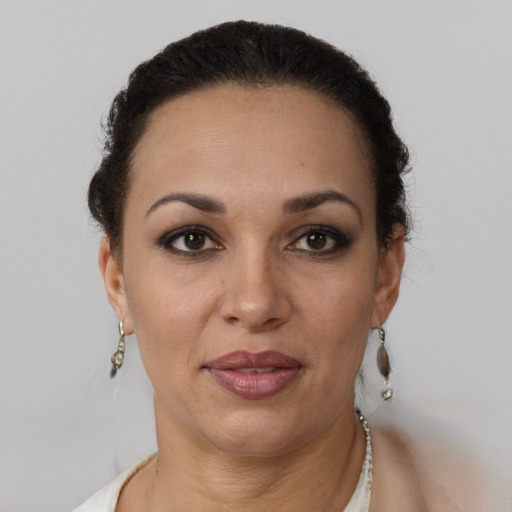 Joyful latino adult female with short  brown hair and brown eyes