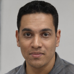 Joyful white young-adult male with short  black hair and brown eyes